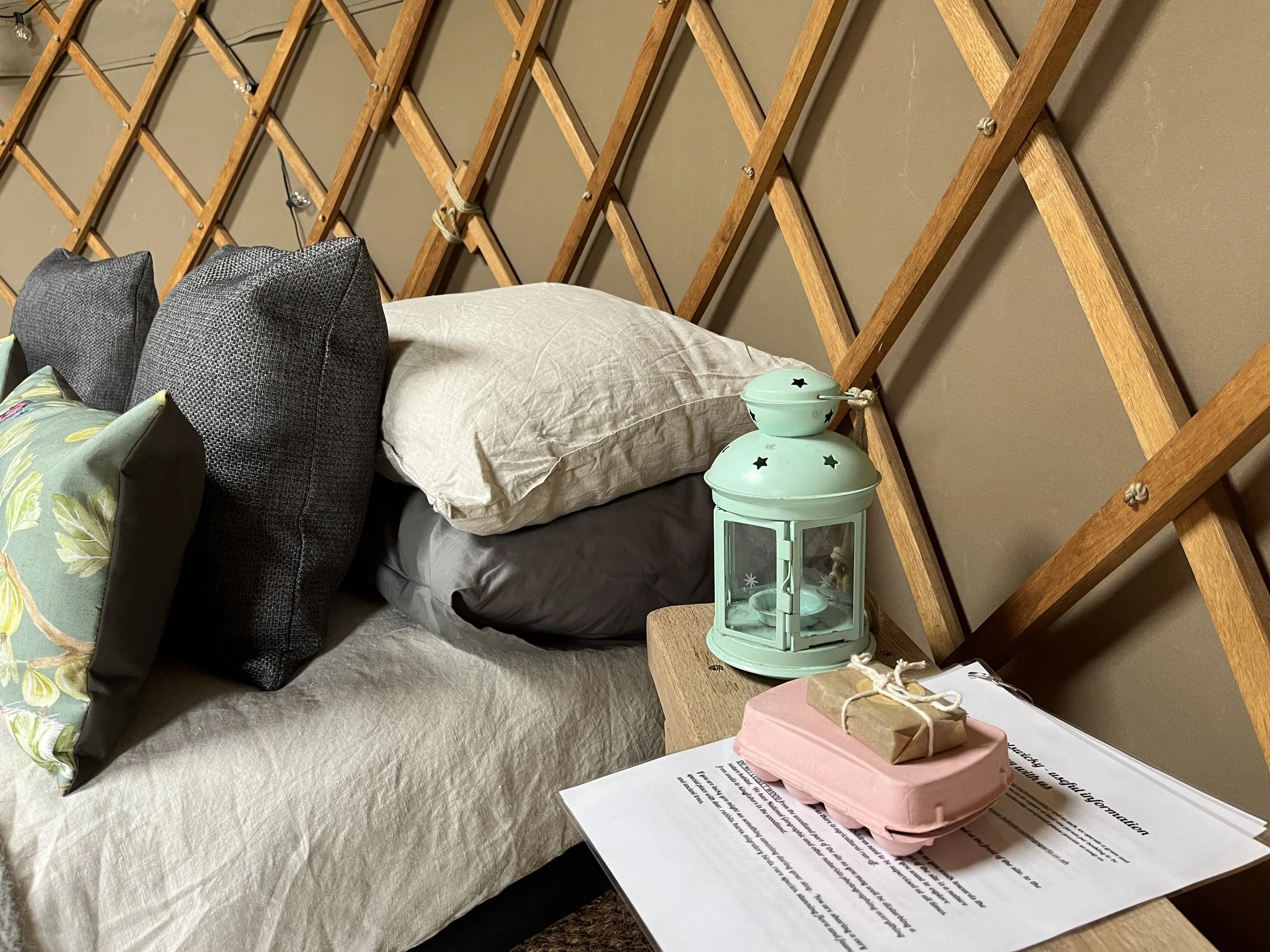 Welcoming yurt interior with homemade soap, a lantern and a pack of fresh eggs