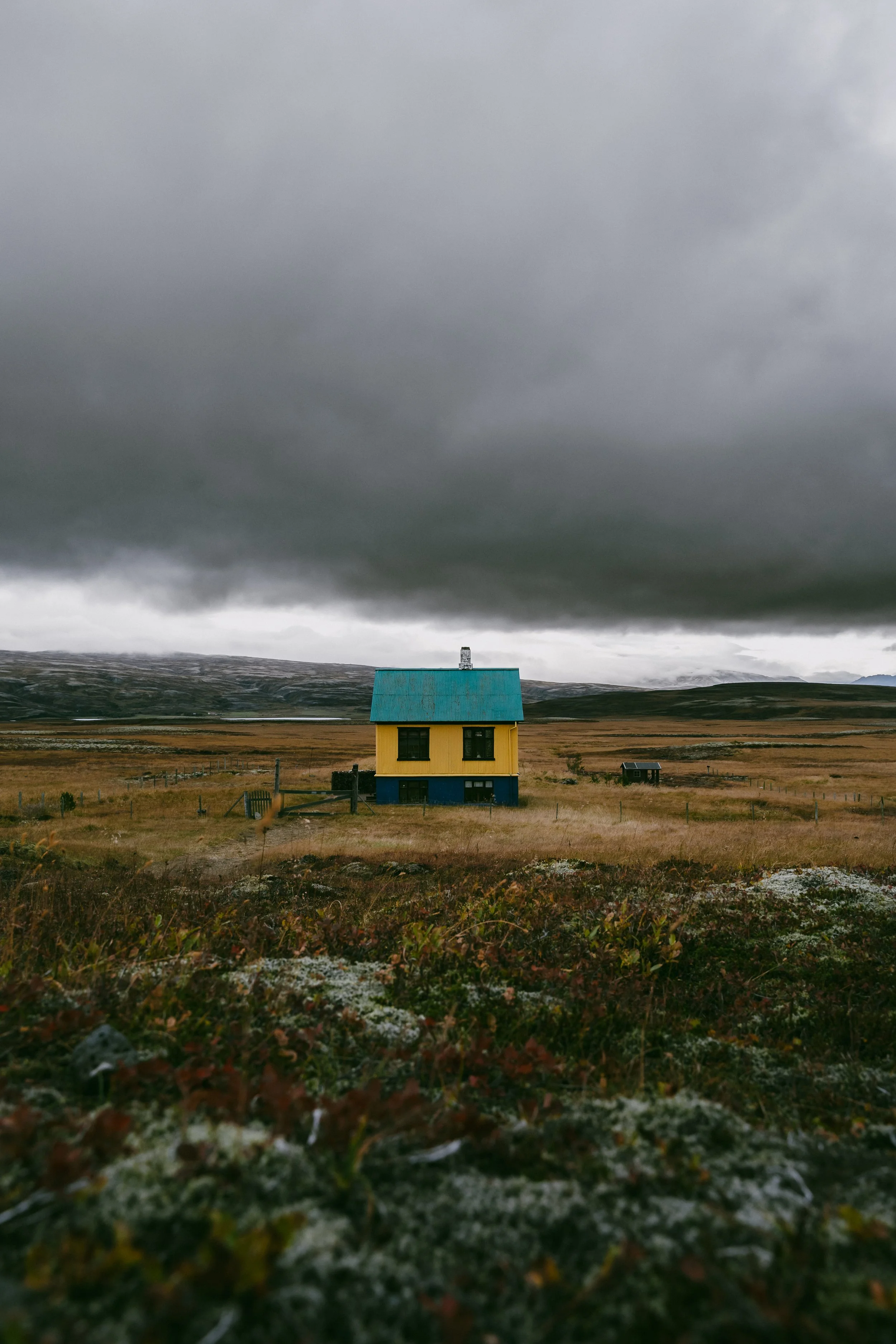 A lone house beneath vast skies in the Icelandic countryside. Minimal, quiet, and deeply atmospheric.