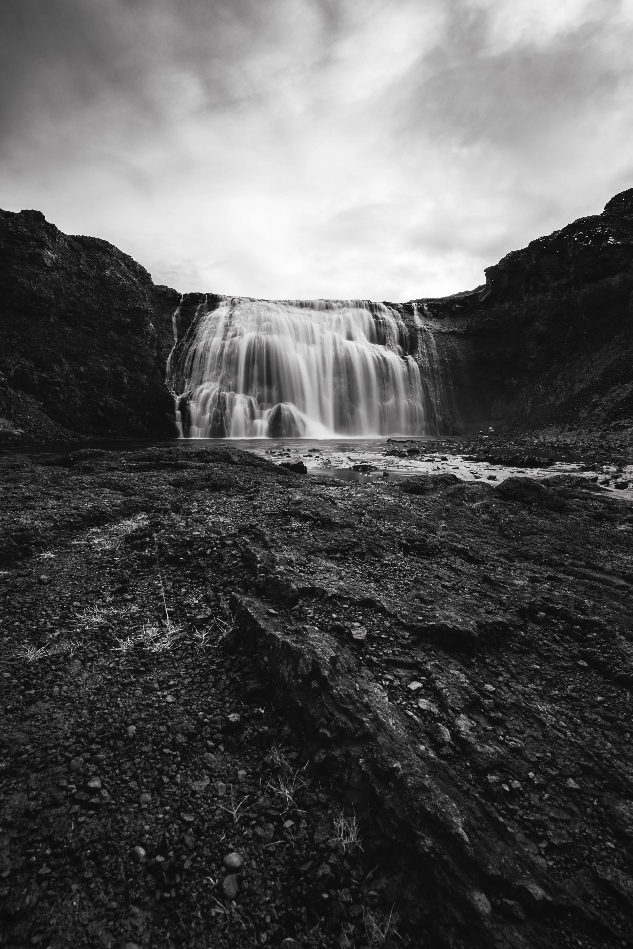 Þórufoss lies hidden from the road, easy to miss unless you know where to look. There’s no marked path—only a faint sheep trail leading down toward the sound of water. Made famous by a brief appearance in Game of Thrones, the waterfall still feels un