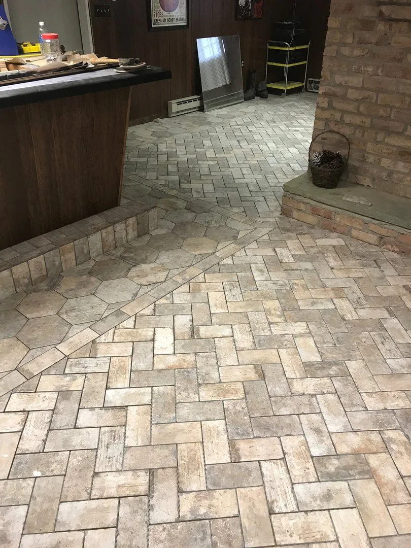 interior with brick pattern flooring and wooden paneling