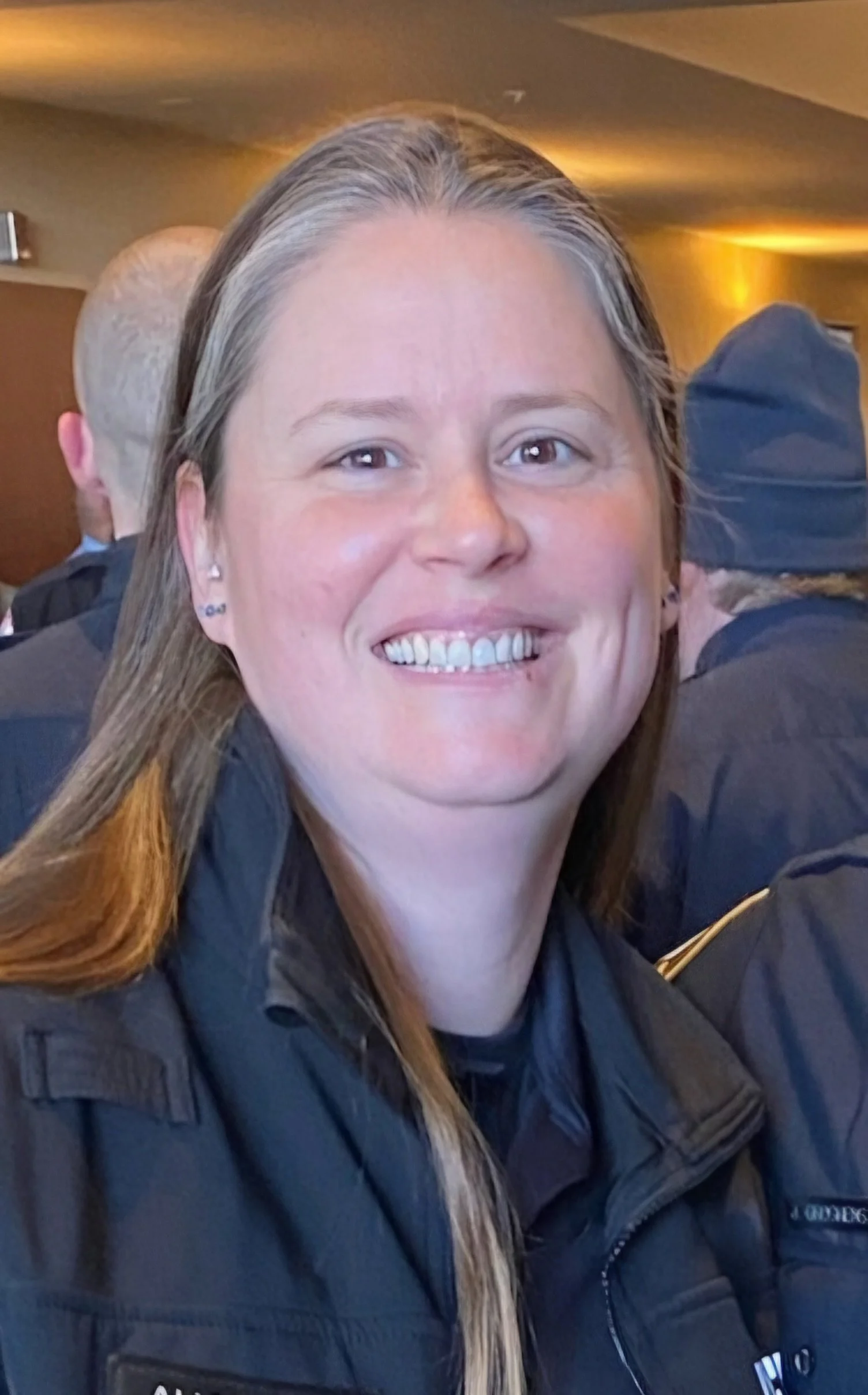 Person smiling in uniform indoors