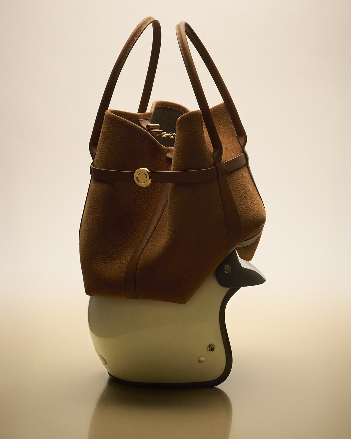Loro Piana bag sat on top of a motor bike helmet for Sunday Times Style