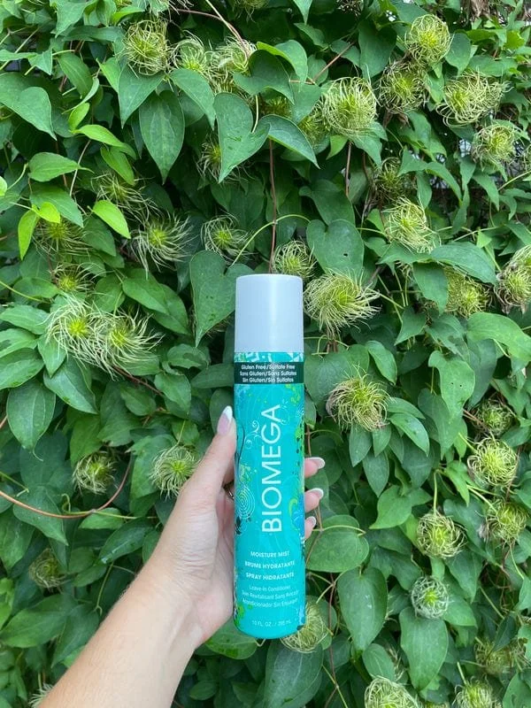 Aquage-Biomega-Moisture-Mist-Conditioner-10oz-against-leafy-background.jpg