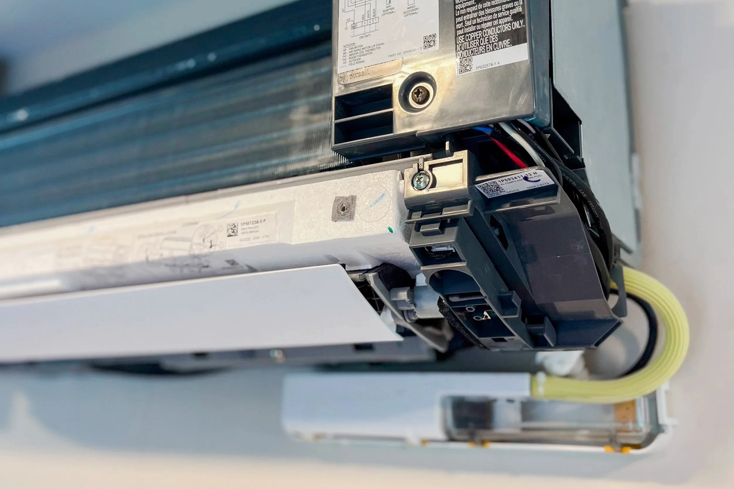 open wall-mounted ductless mini-split indoor unit during HVAC service