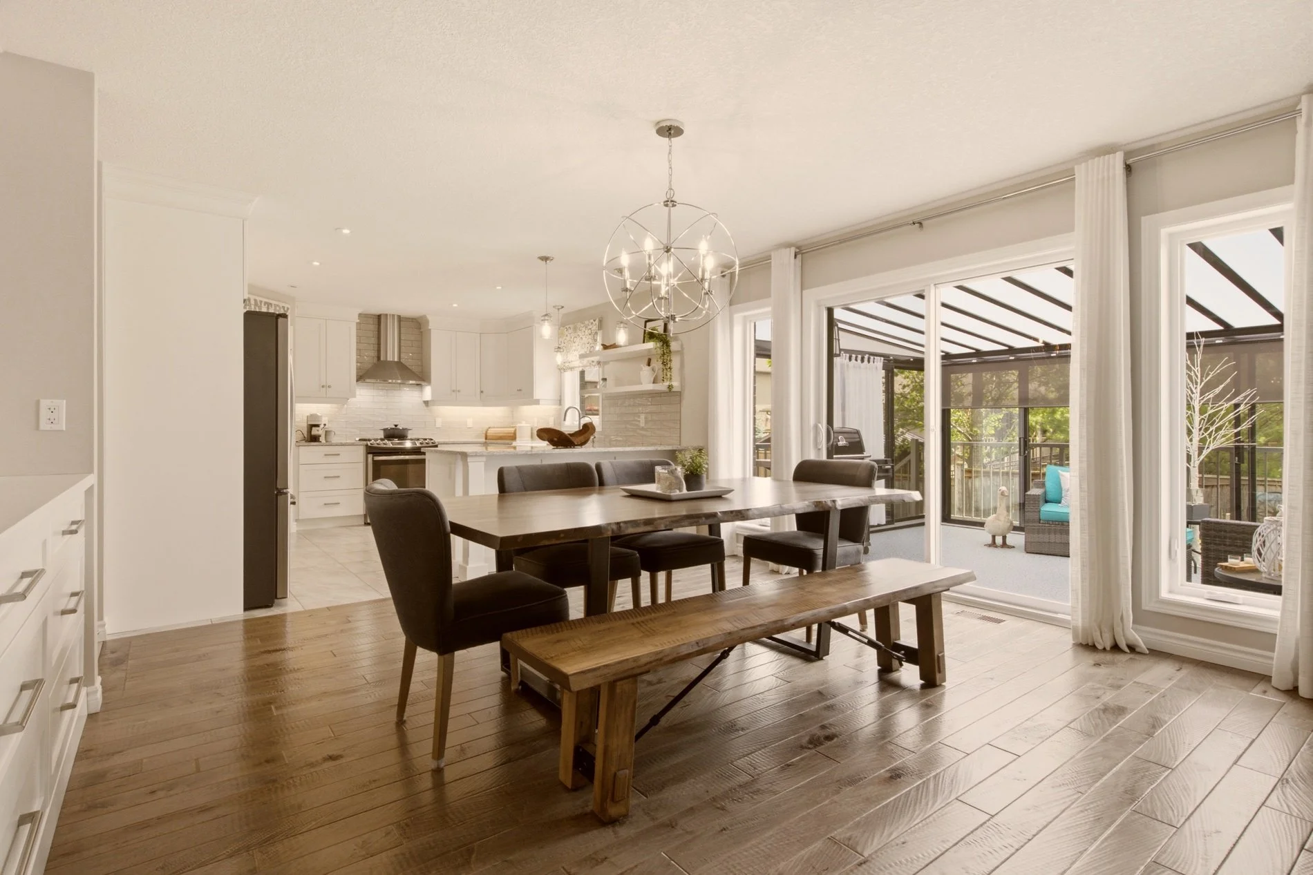Bright open-concept dining room and white kitchen in an Elora, Ontario home