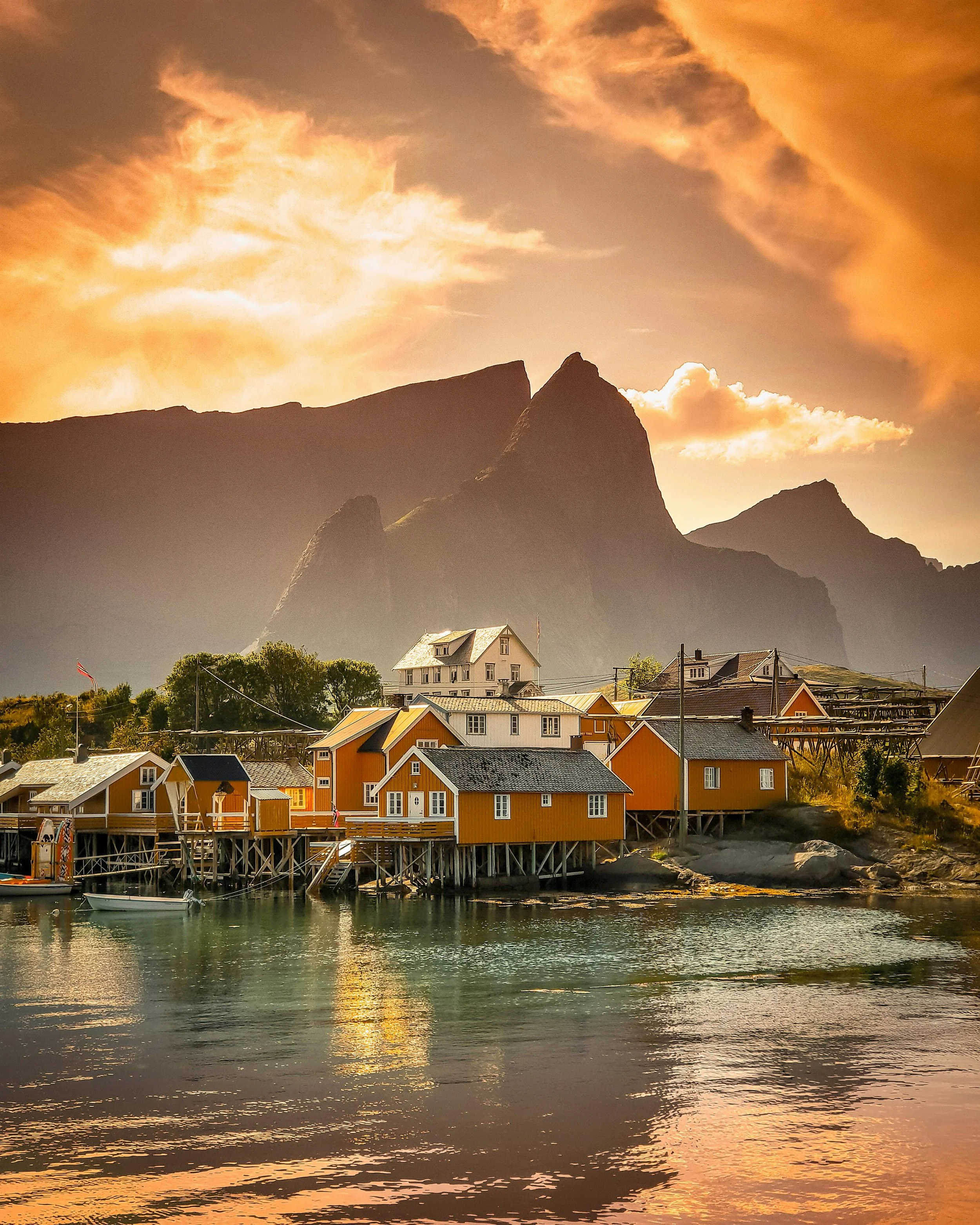 Iconic fishermens cabins on the waters edge at Sakrisøy in Reine, Lofoten, Norway