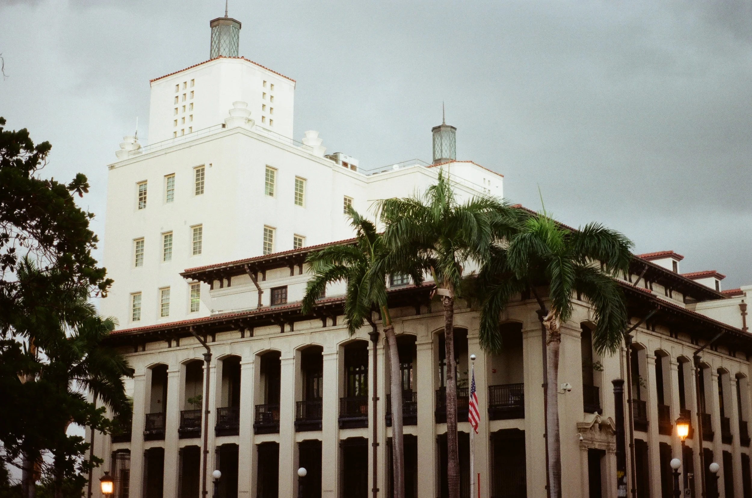 Historic building with columns and palm trees