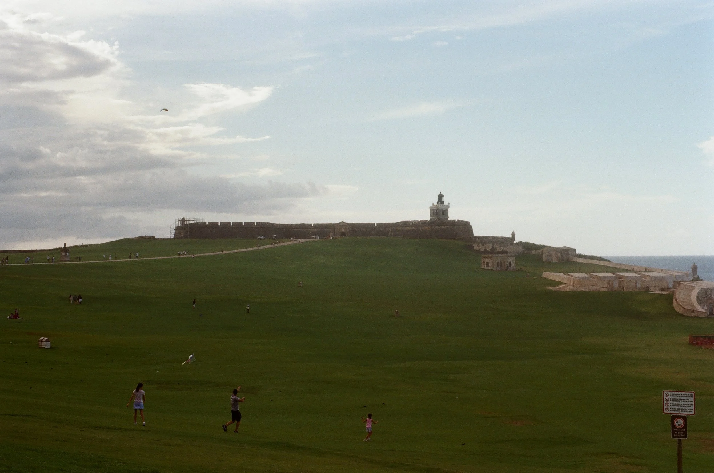 Lawn with people flying kites near El Morro Fort in San Juan, Puerto Rico.