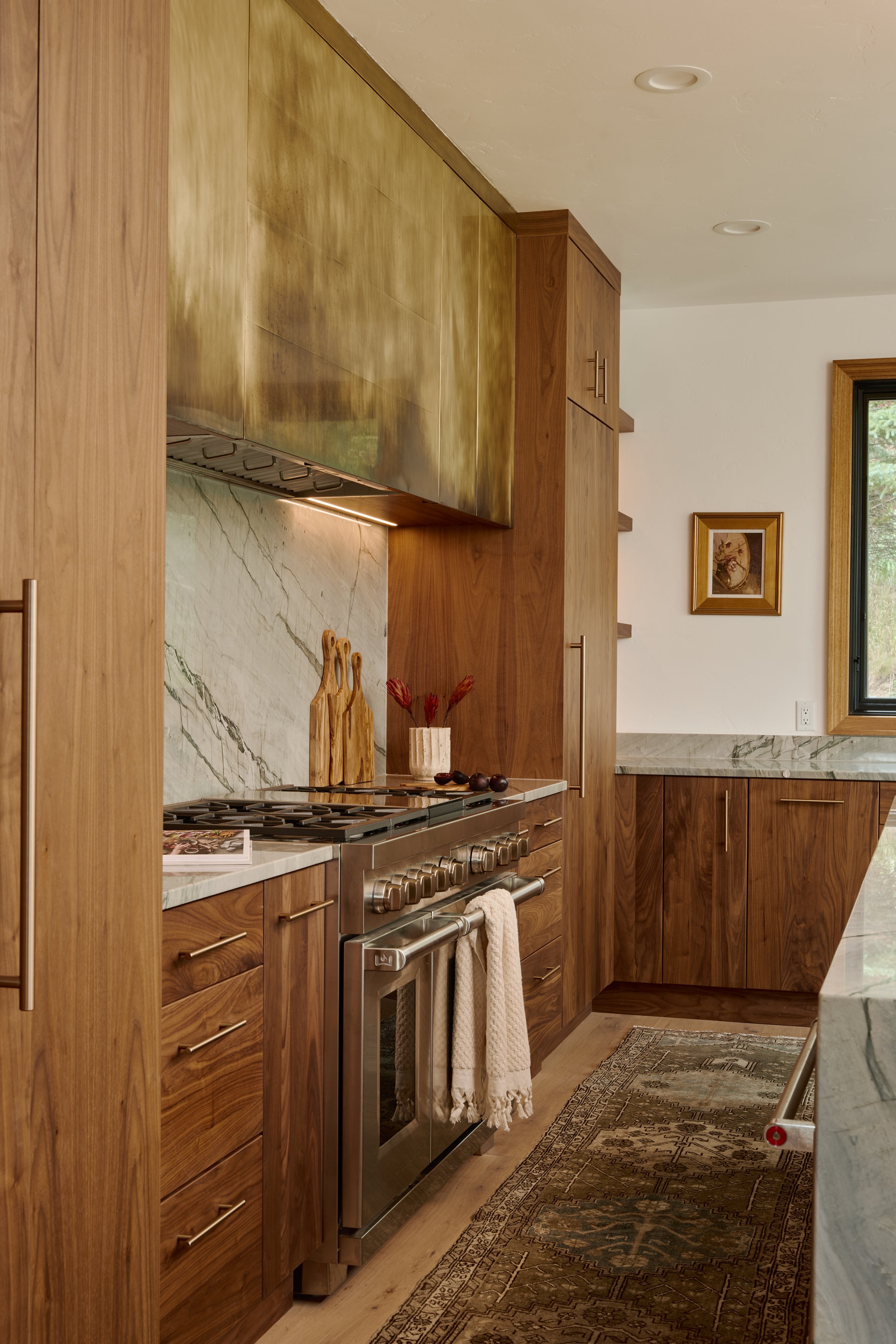 Walnut cabinets, brass hood