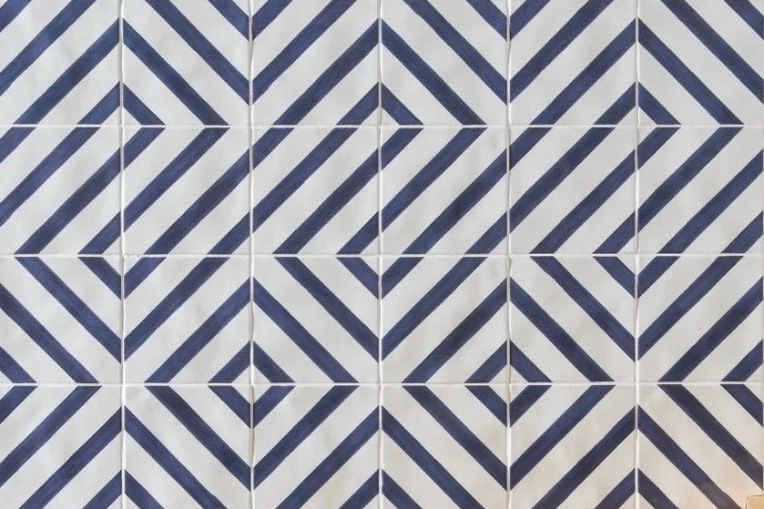 Close-up of decorative ceramic tiles with a geometric blue and white pattern.