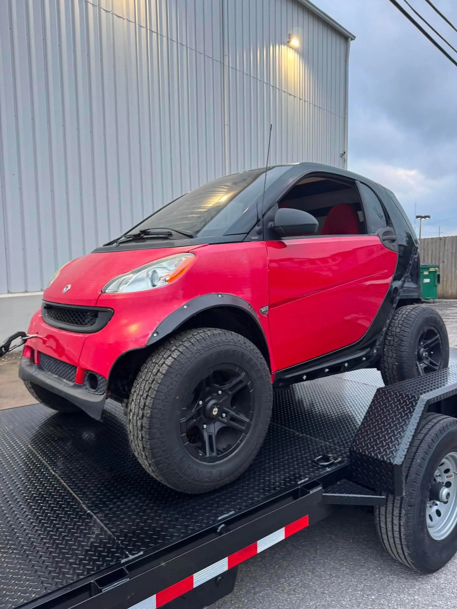 Smart car loaded on a 20ft power tilt trailer