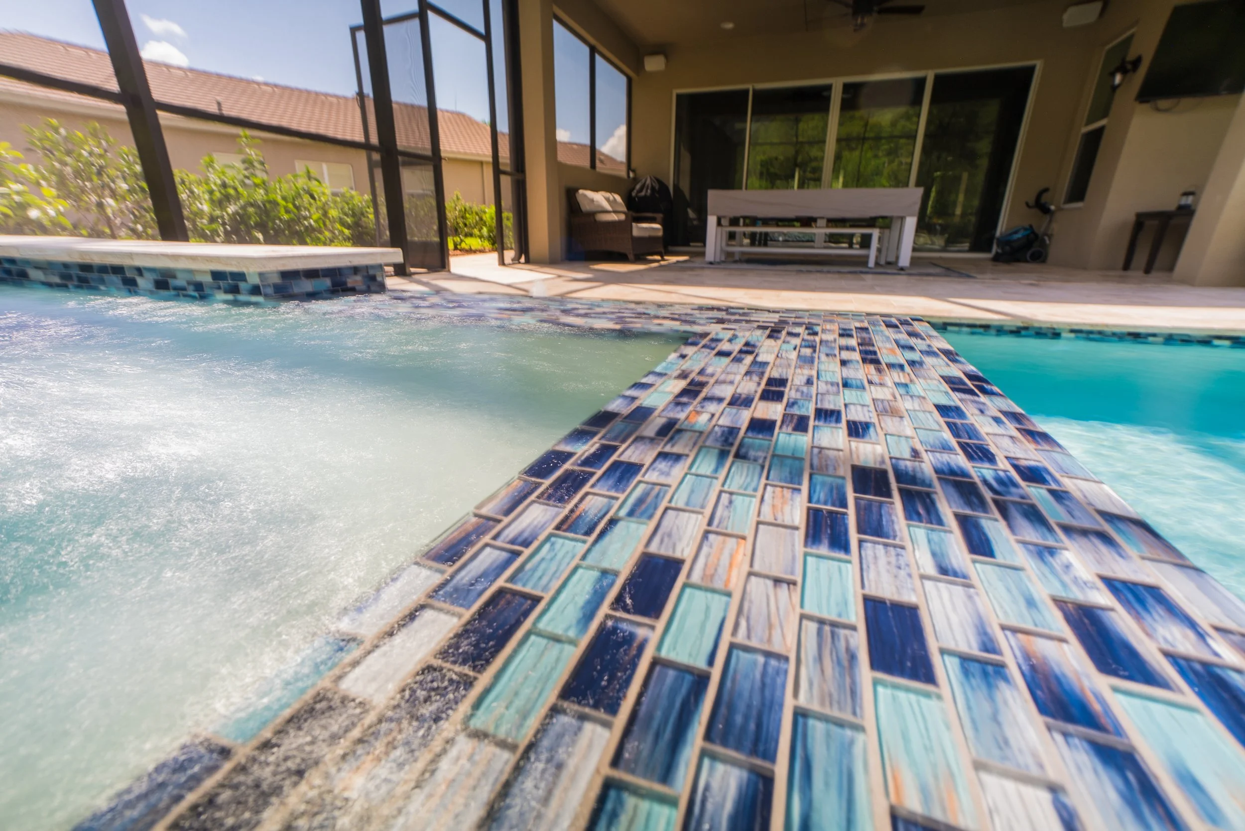 Mosaic blue tile pool and spa design