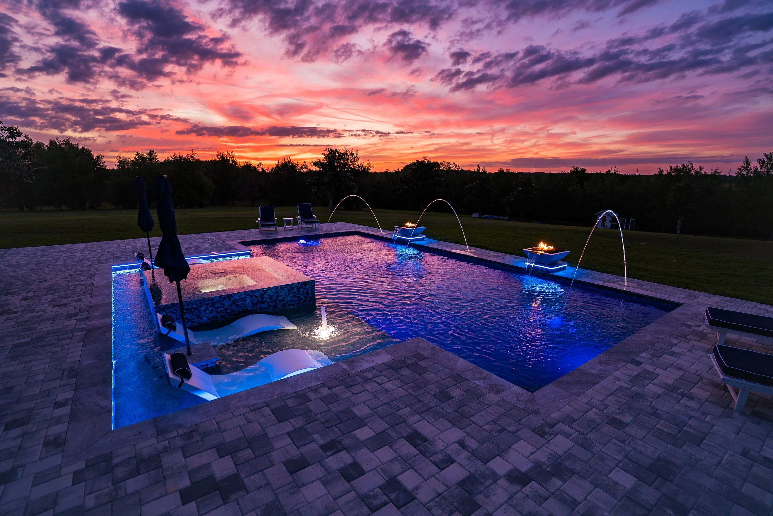 A new, custom swimmming pool and spa, fire bowls, LEDs, bubblers at sunset