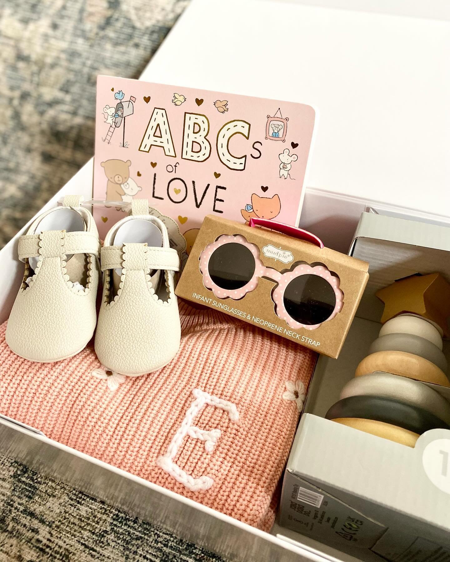 Why does everything feel more bougie in a magnetic closure box?! 💅🏻🤌🏻 We put together the cutest Apparel Gift Bundle for Emmanuelle 💕 Our signature knit sweater alongside a pair of the tiniest leather booties, ABCs of Love board book, a wooden t