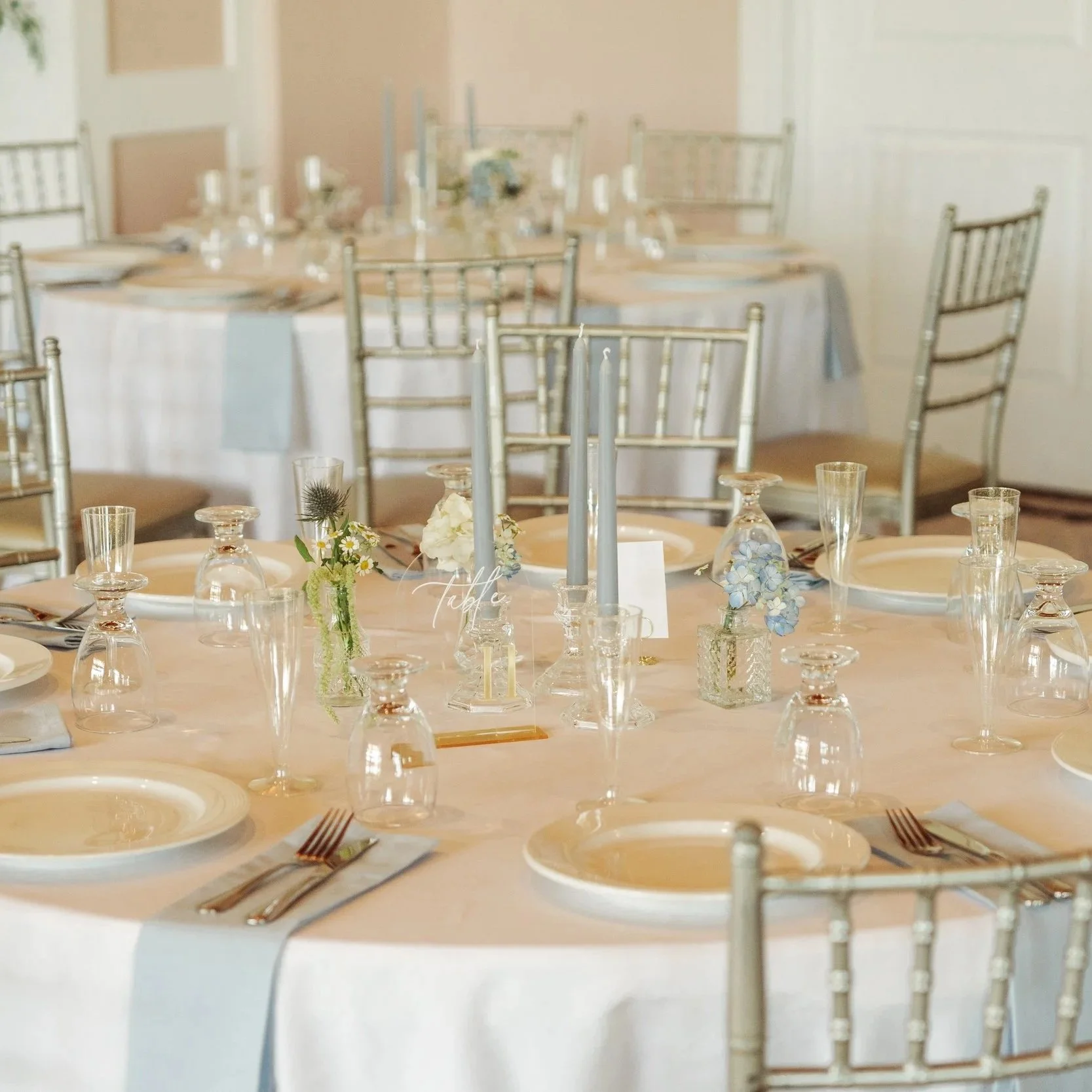 Elegant banquet table set with white plates, silverware, glassware, and floral centerpieces in Fort Worth Texas.