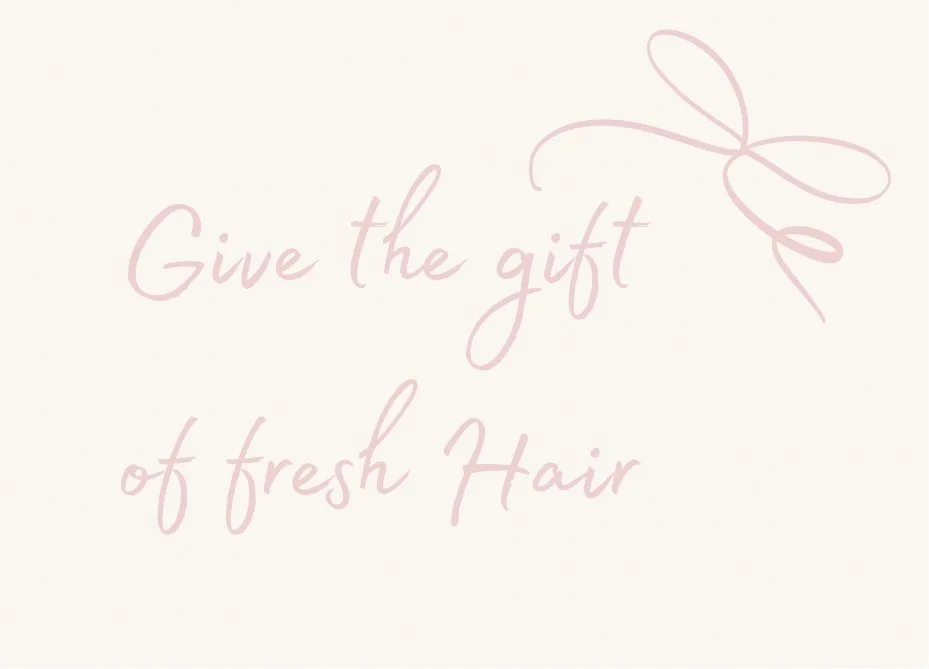 A light-colored background with pink cursive text that says "Give the gift of fresh hair" and a pink outline of a bow.