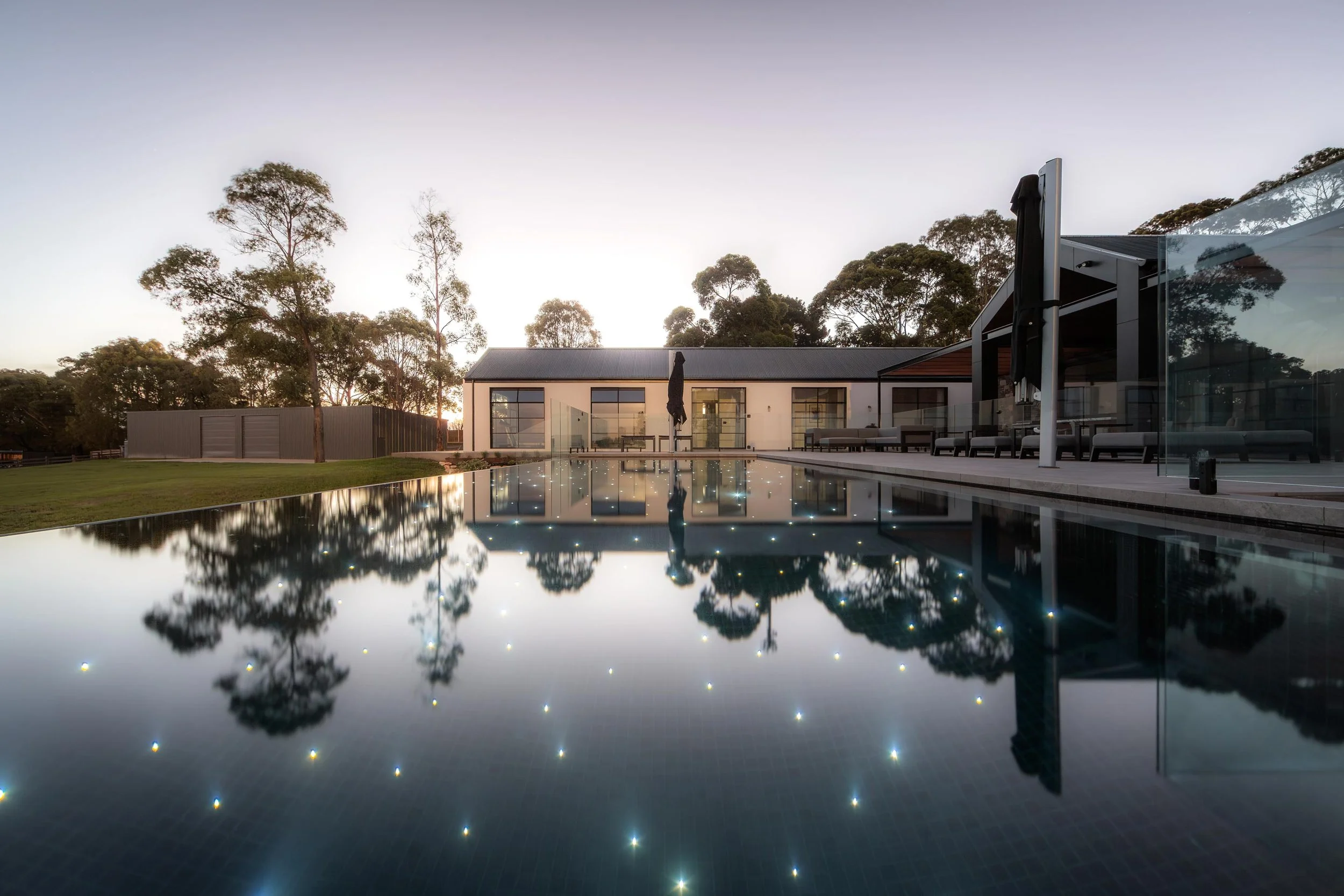An award-winning swimming pool illuminated with subtle, starlight-like lighting.