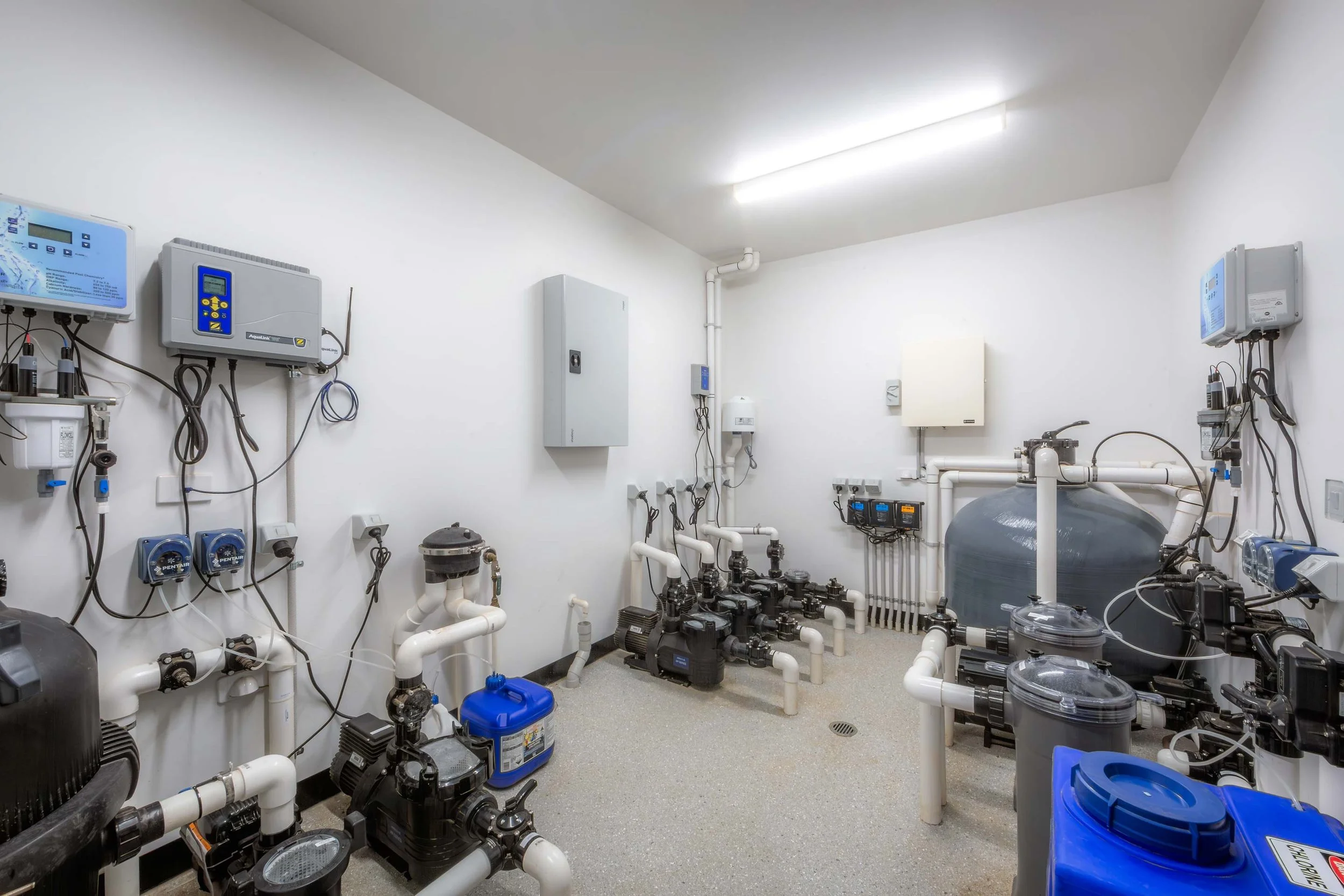 Pool filtration system with pumps, water treatment equipment, pipes and control units in a dedicated plant room