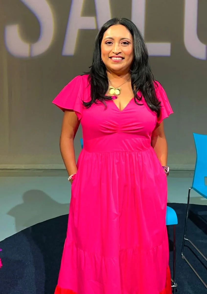 Melanie Mendez-Gonzalez, founder of Que Means What and MMG Media, in a confident colorful headshot