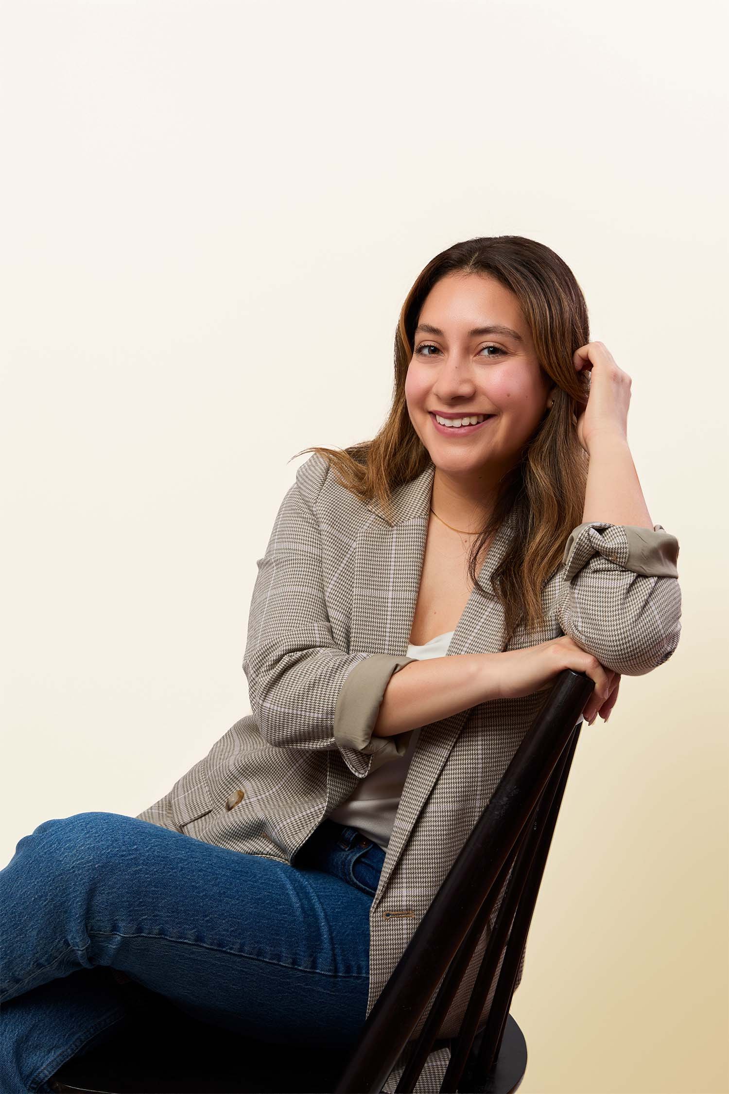 Rosa Pruneda, Latina Houston PR consultant and Hispanic marketing consultant serving small businesses and founders, sitting in a blazer and smiling warmly