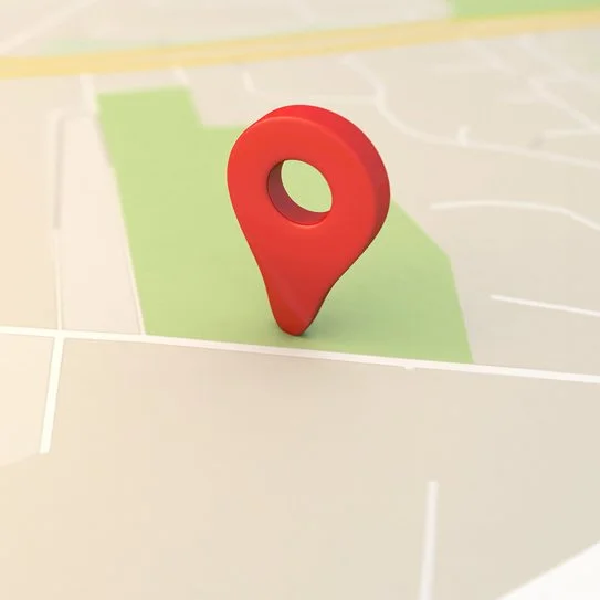 A red map marker on a digital map showing streets and a park area.