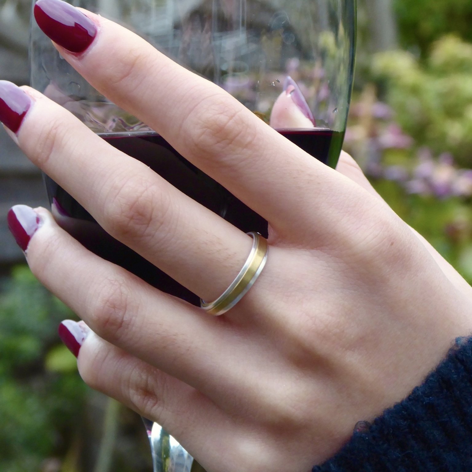 Bound Unity Ring modelled on hand - Silver & Brass