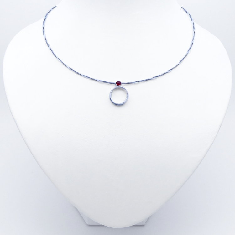 Silver pendant with a cornelian cabochon on a braided wire cable