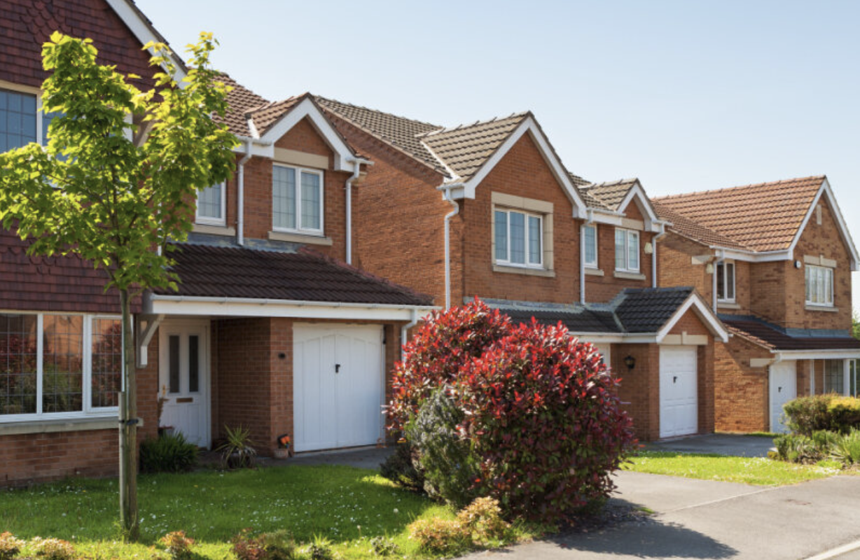 Three houses with green spaces in front