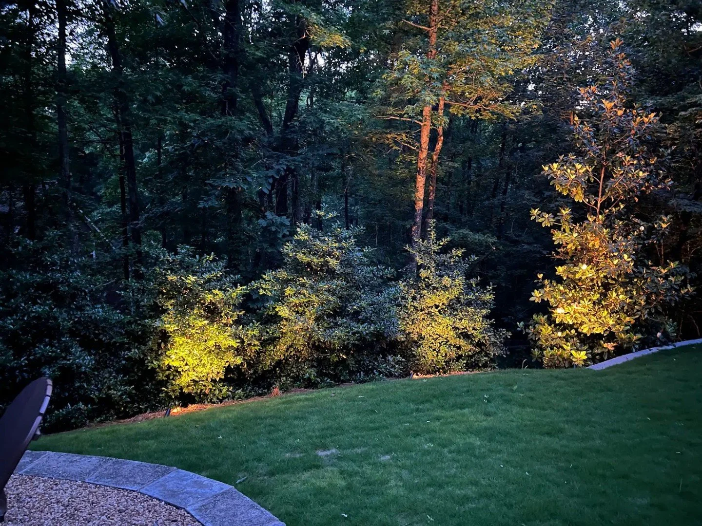 Let your outdoor space shine, day and night, with custom solutions like this retaining wall, sod, and lighting.

Reach out for a consultation today.