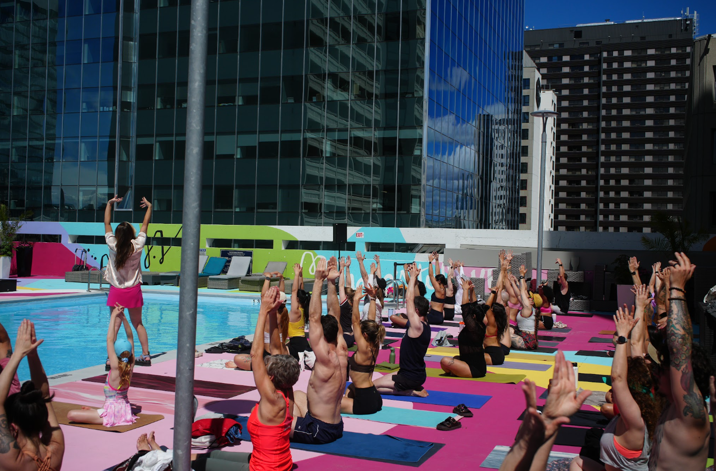 The Rogue community doing yoga by the pool.