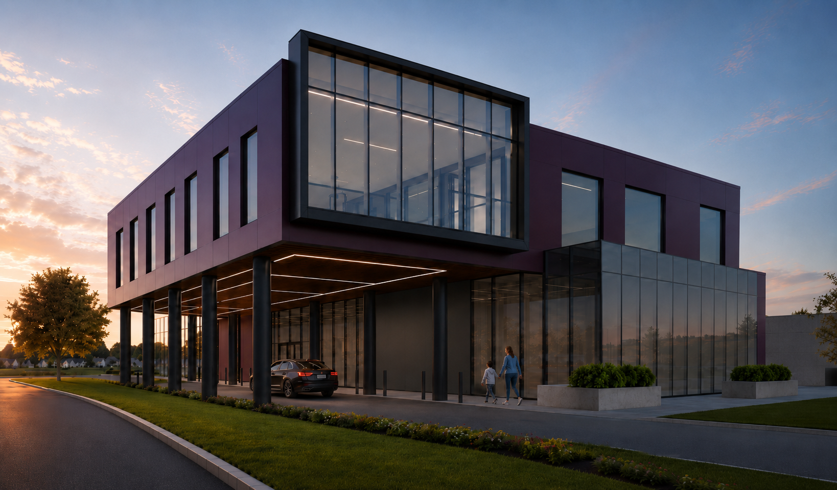 Modern multi-story building with large glass windows, supported by black pillars, with a car parked outside and a woman walking with a child at sunset.