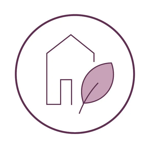 Outline of a house with a leaf overlapping the front, enclosed in a circle.