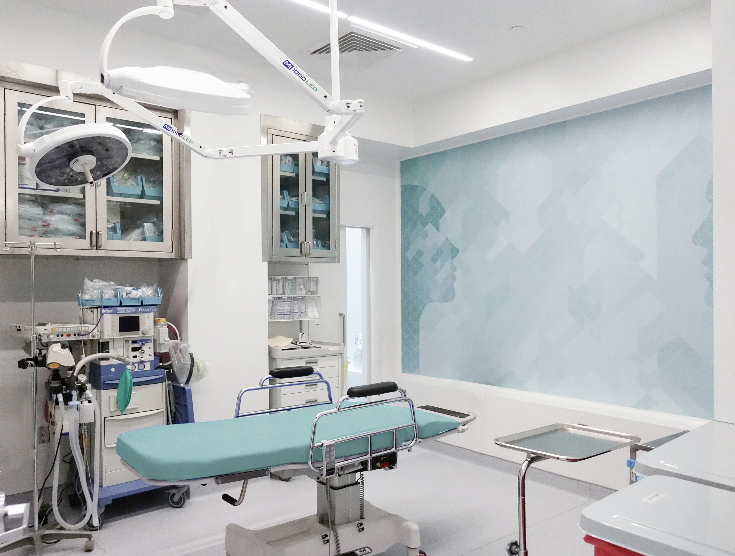 Empty hospital operating room with medical equipment, an operating table with teal padding, and various machines and cabinets. healthcare, wellbeing. salutogenic, wayfinding. Toronto, Dallas Texas, Miami, and Park city.