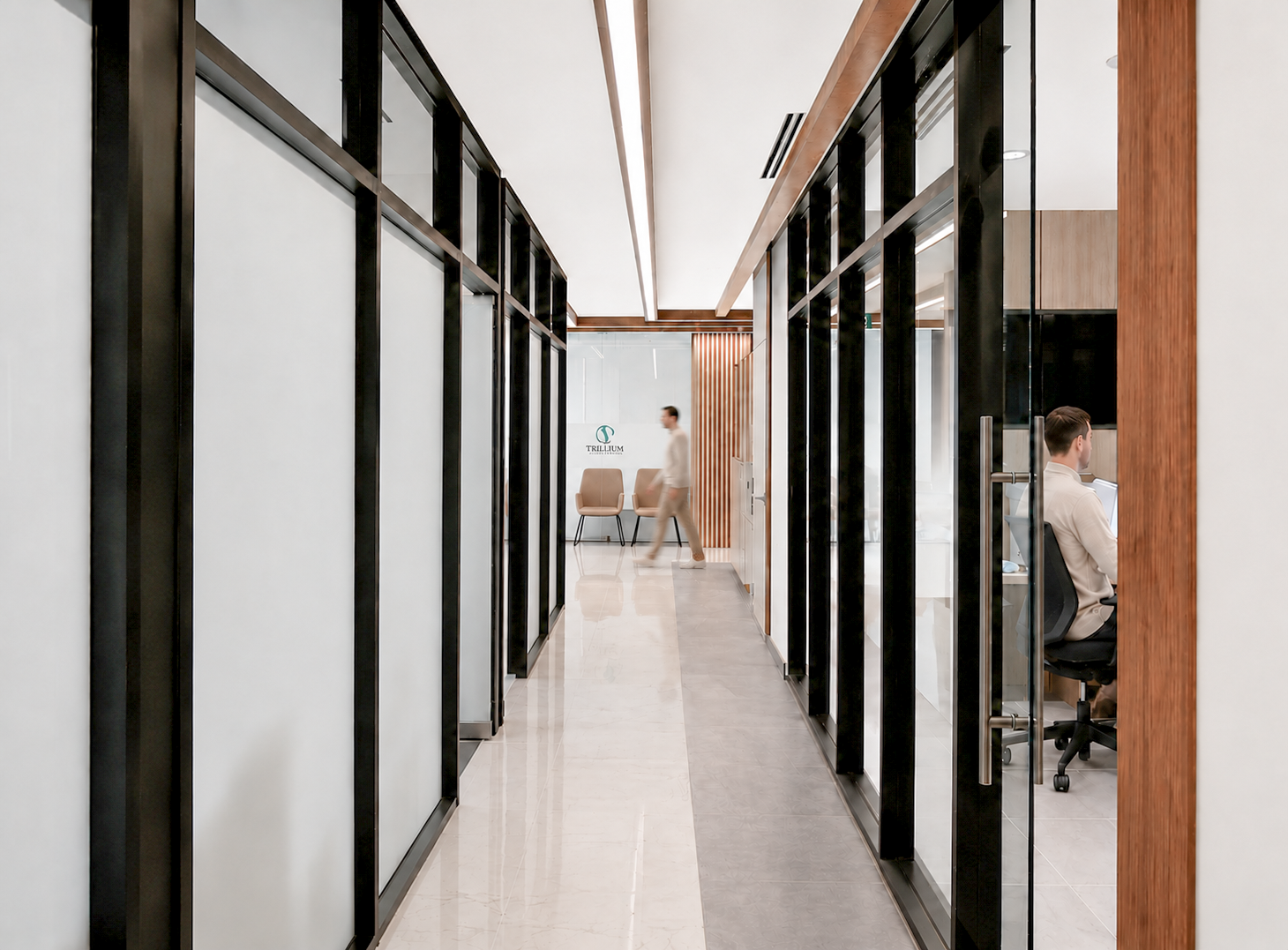 Modern office corridor with glass walls and chairs at the end. healthcare Architecture. wellbeing and wayfinding. Salutogenic design. Inspiration for Toronto, Dallas, Park city, Texas, Miami.