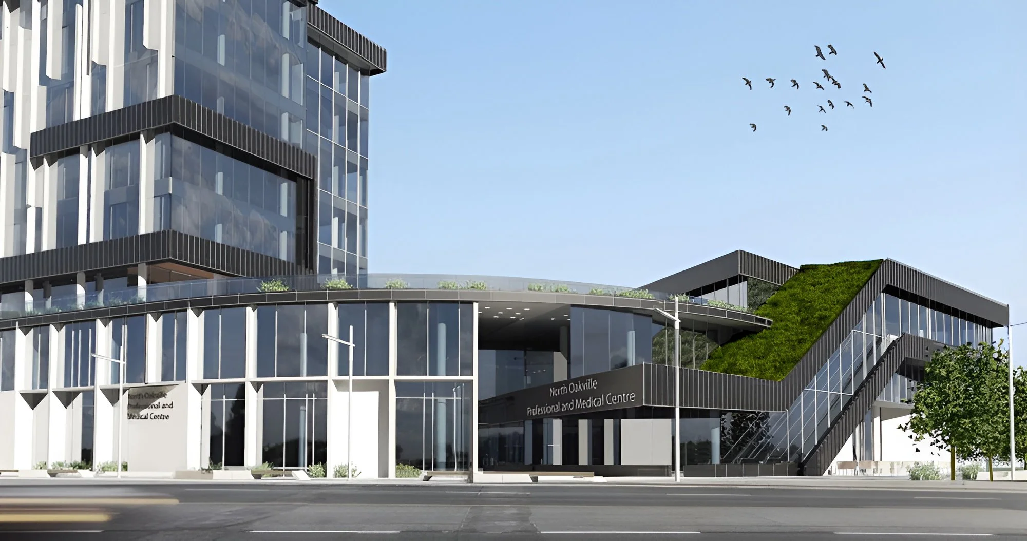 medical center building with large glass windows and a sign that reads 'Metro Oakville Abdominal and Medical Centre'. The building has an architectural design with black and white framing, green rooftop garden, and an external staircase. Toronto
