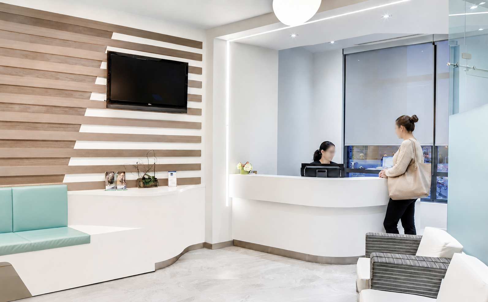 Modern reception area with a wooden accent wall, flat-screen TV, potted plants, and seating with chairs and couches in a well-lit space with large windows. healthcare, wellbeing. salutogenic, wayfinding.  Toronto, Dallas Texas, Miami, and Park city.