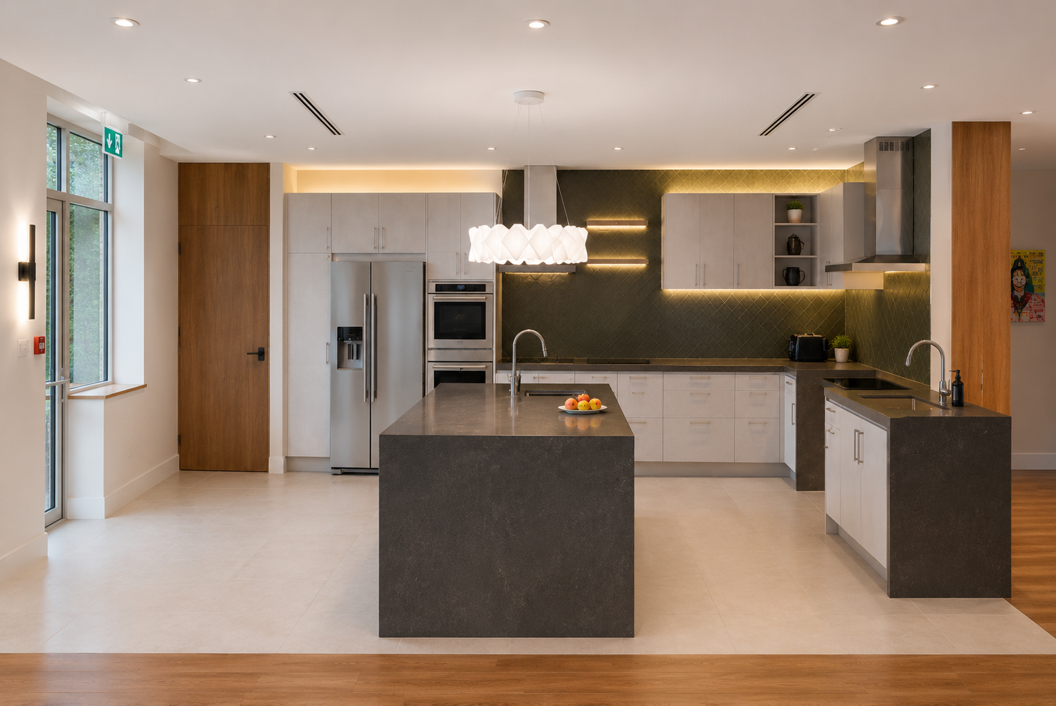 Modern kitchen with white cabinetry, black countertops, and a central island with fruit. Stainless steel appliances and a green tiled backsplash. Wooden accents and open shelving, with a large window and contemporary lighting.