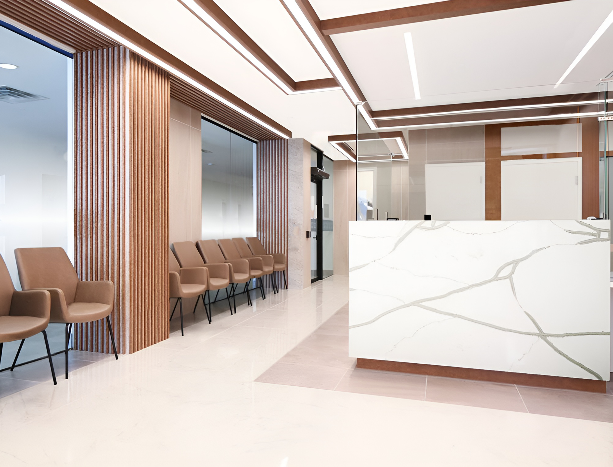 Modern interior space with waiting area, featuring brown chairs, vertical wooden slats, glass partitions, a marble reception desk, and ceiling with wooden beams and integrated lighting. Healthcare. Inspiration for Toronto, Dallas, Park city.