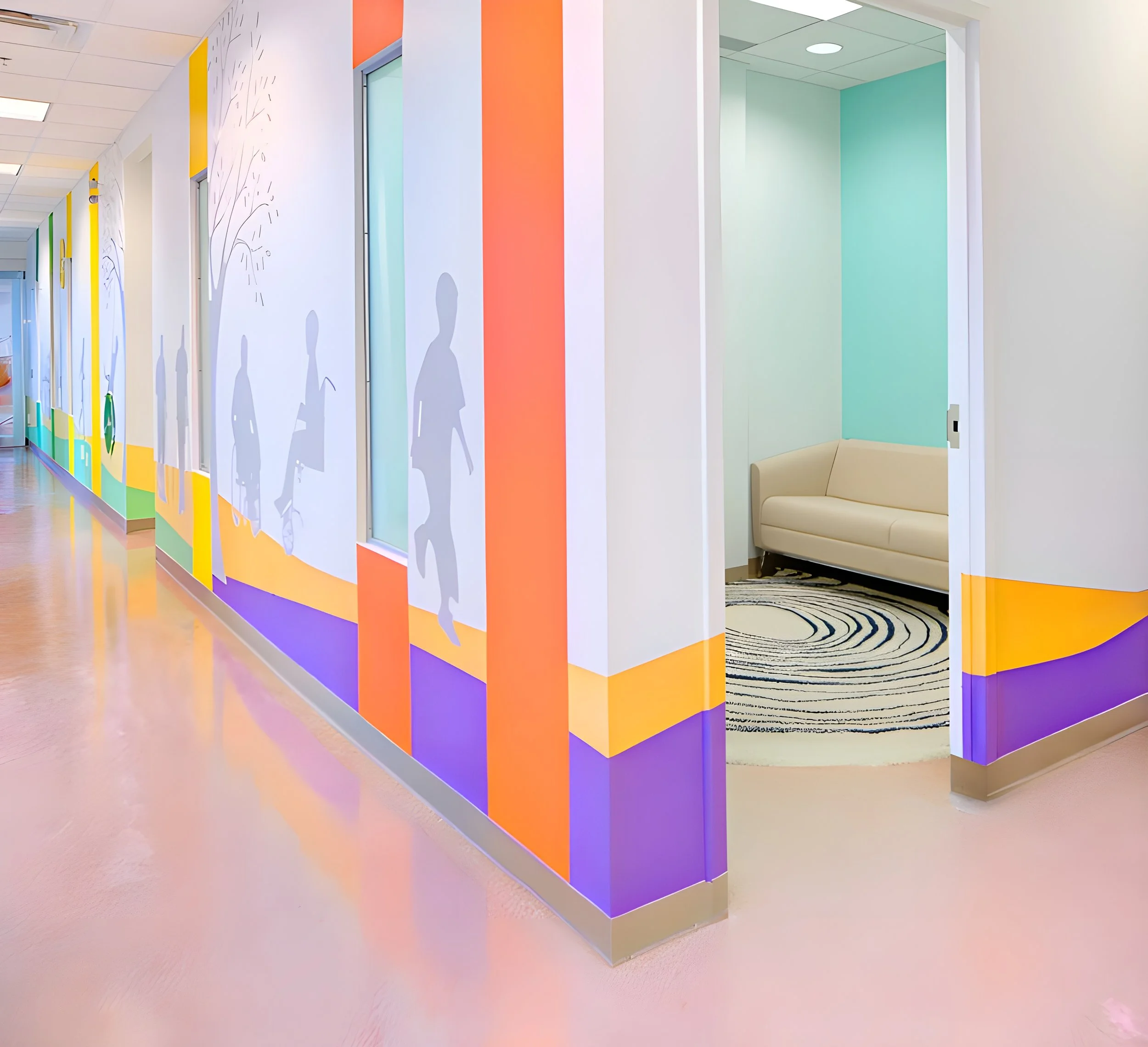 Colorful hallway with silhouette cutouts of children on the walls, a corner seating area with beige cushion, and a circular black-and-white patterned rug.