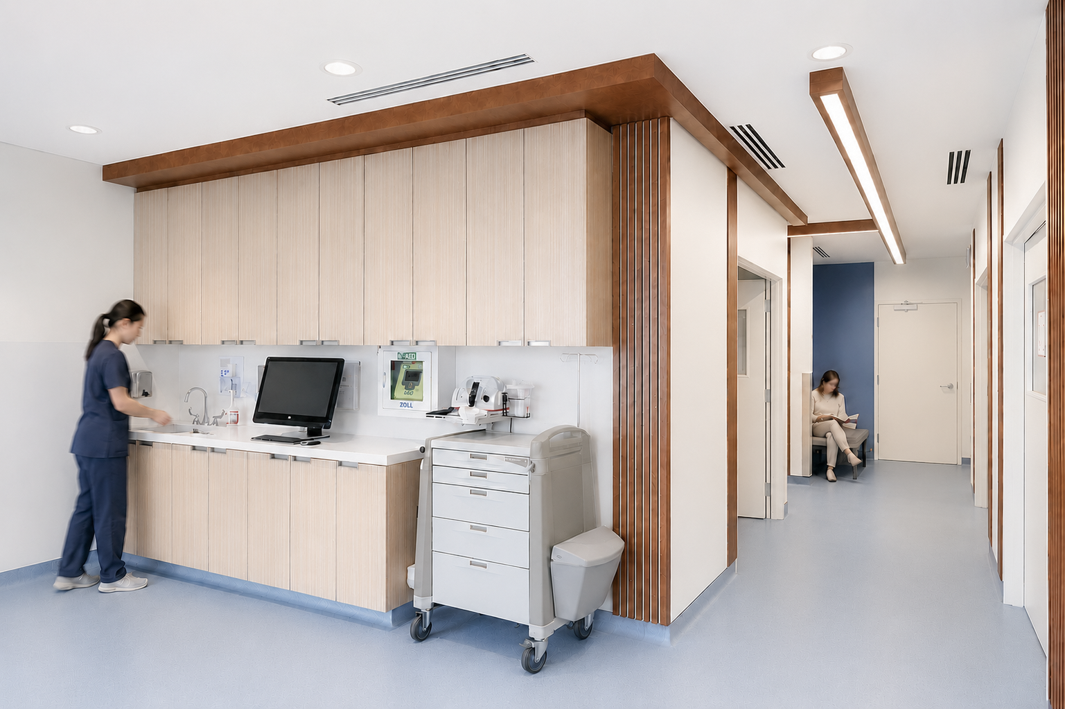 Hospital nurse station with wooden cabinetry, a computer, medical supplies, and a rolling cart, in a clinical setting with clean white walls and ceiling, and hallway with blue accent wall. Healthcare. Inspiration for Toronto, Dallas, Park city.