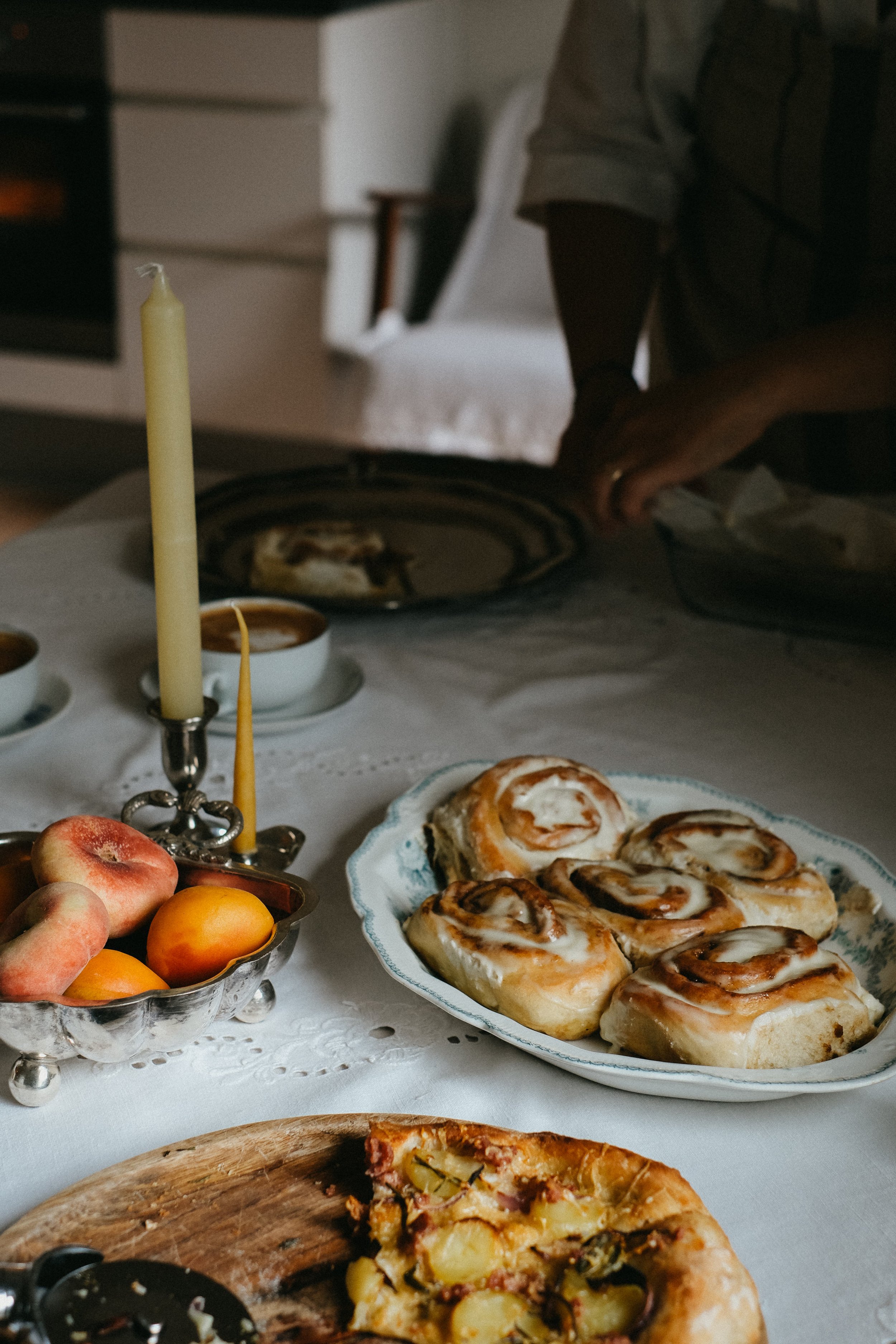 homemade cinnamon buns, vintage coffee cups and fruit bowl - moody product photography
