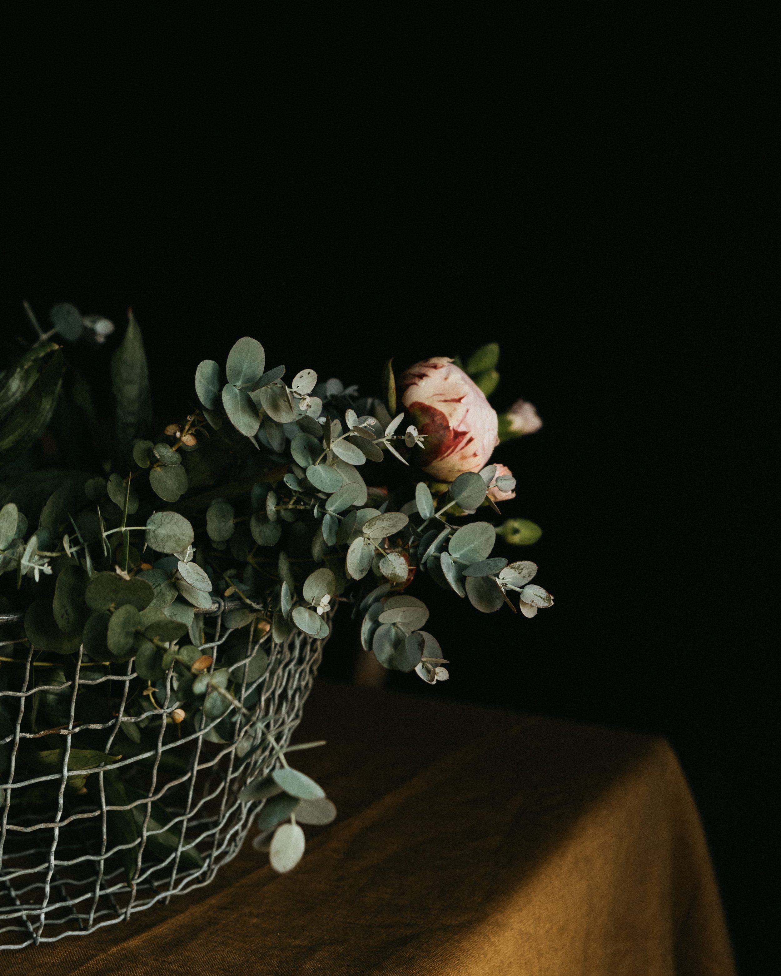 Snippets from a photo shoot, featuring a flower basket, a linen tablecloth and candles. Part of a series for CrisannaBoutique, my photography captures the magic of slow, every day moments, and seamlessly incorporate the products of the brand in the i
