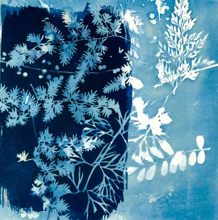 Silhouette of a person taking a selfie with a background of layered plant and leaf patterns in shades of blue and white.