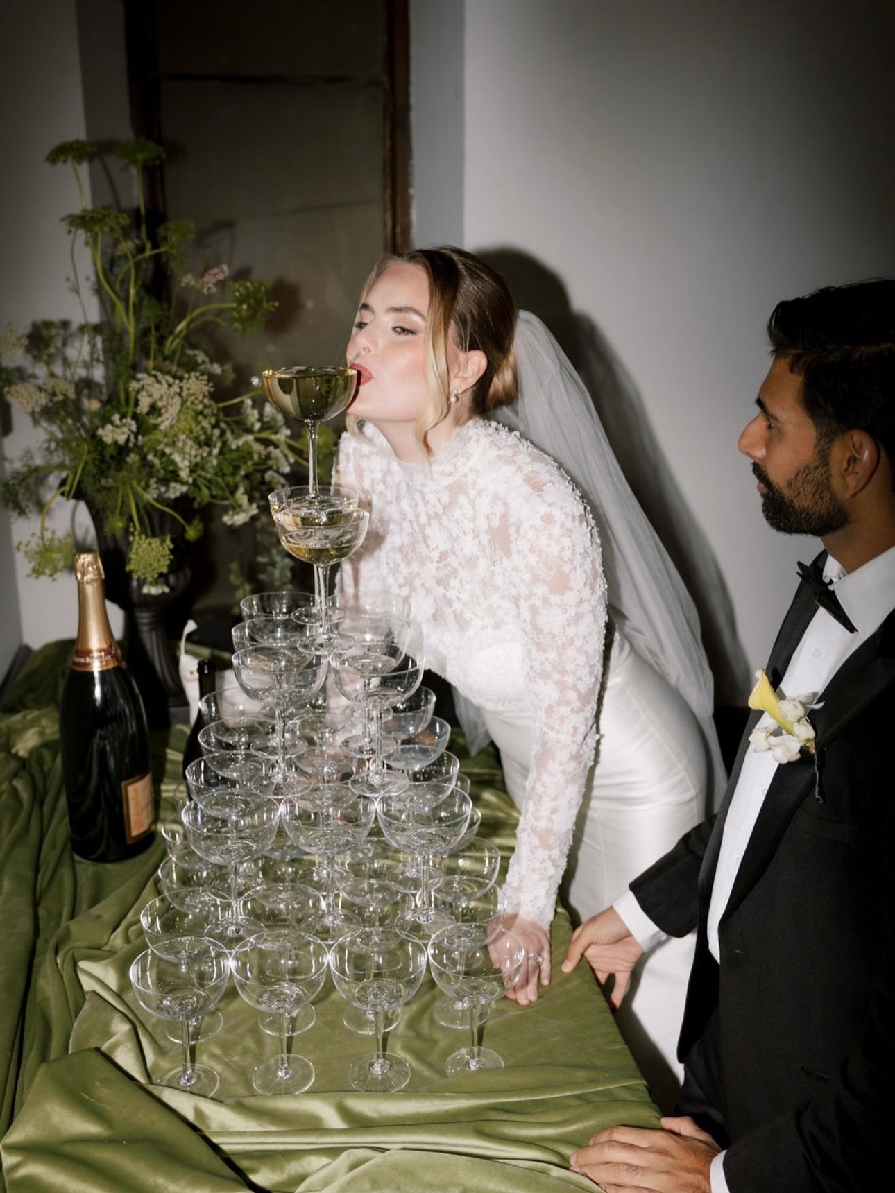 V&rsquo;s wedding felt like stepping into something sacred, where every detail was chosen with intention and every moment held meaning.

Soft light poured through stained glass windows, casting color across a room filled with so much love. Champagne 