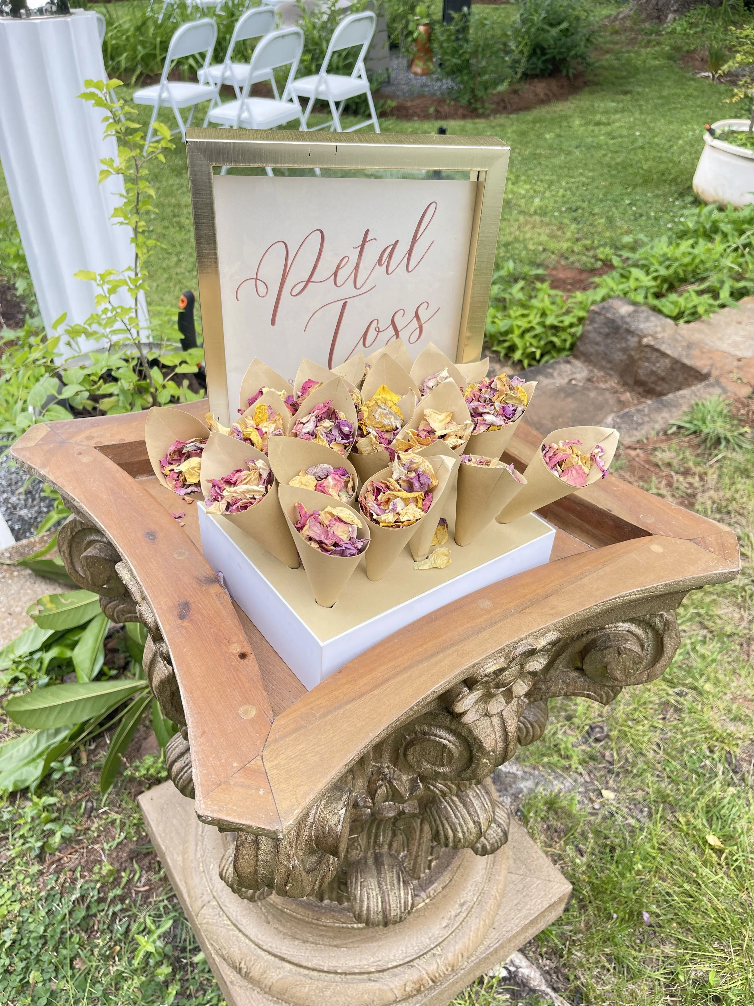 petal toss display on a century furniture collumn. Petal toss signage sits next to it.