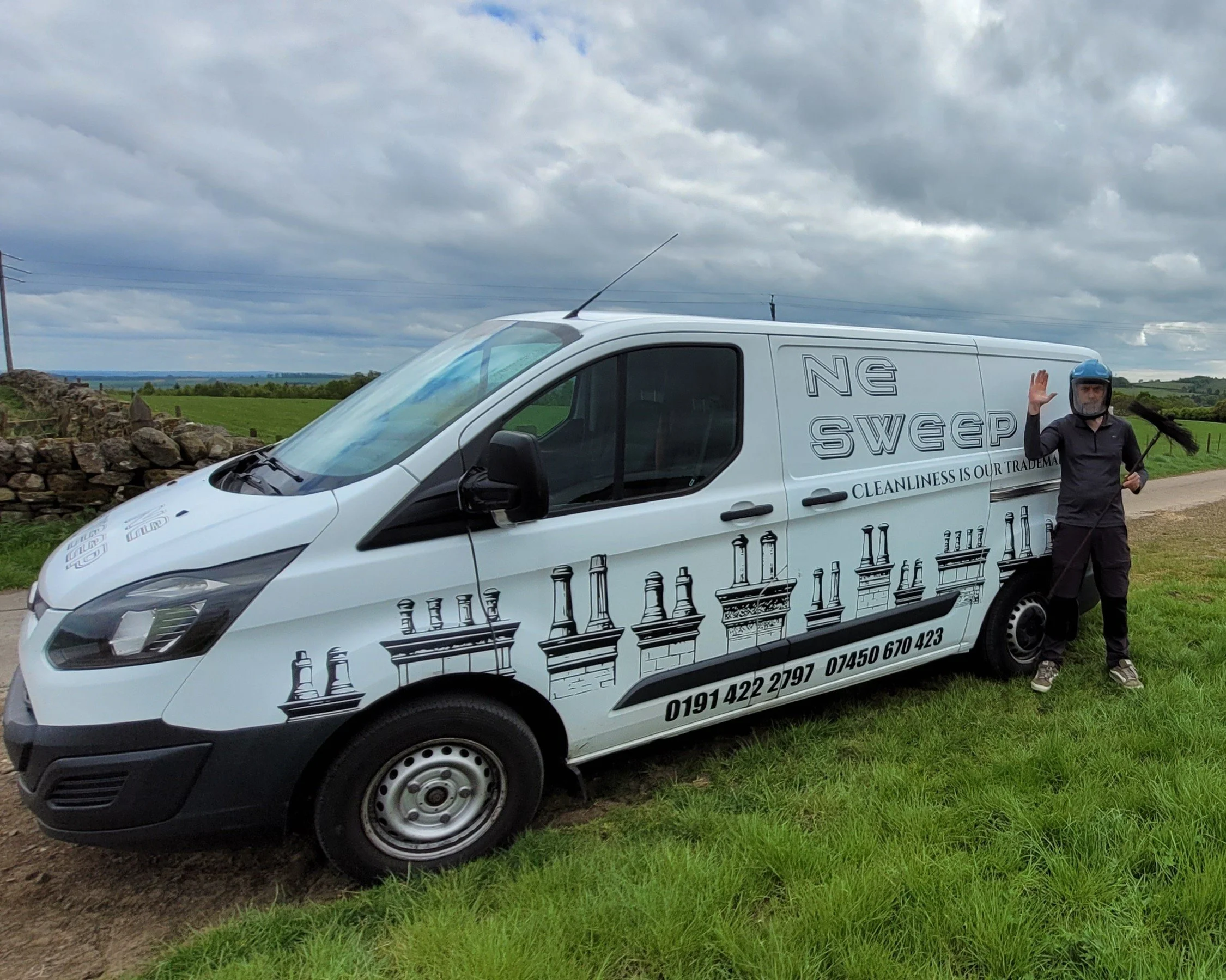 Friendly owner of NE Sweep waving hello outside of his van in northumberland