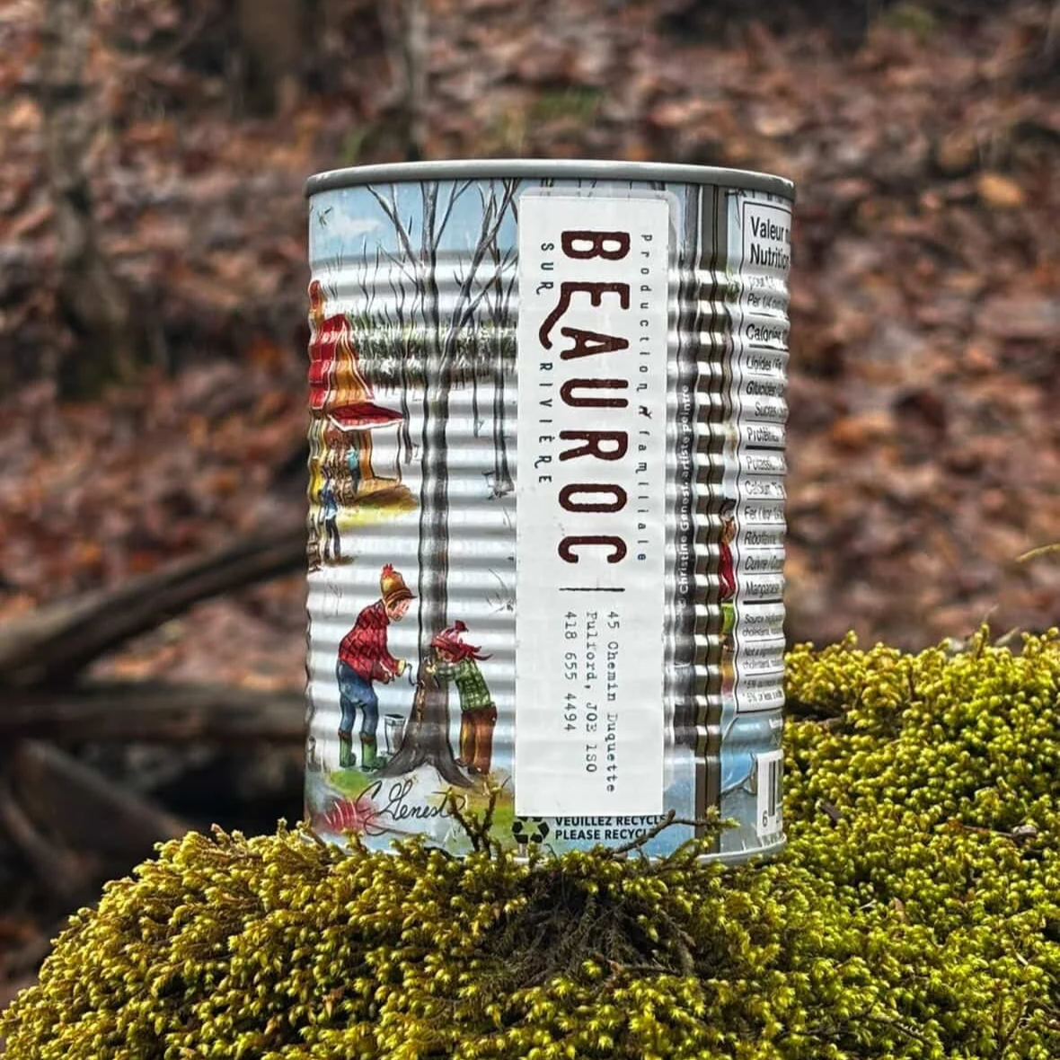 can of Beauroc maple syrup on moss in the forest