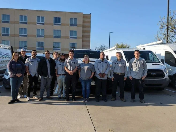 Plumb Quick plumbing team standing together in front of service trucks in Plano, TX