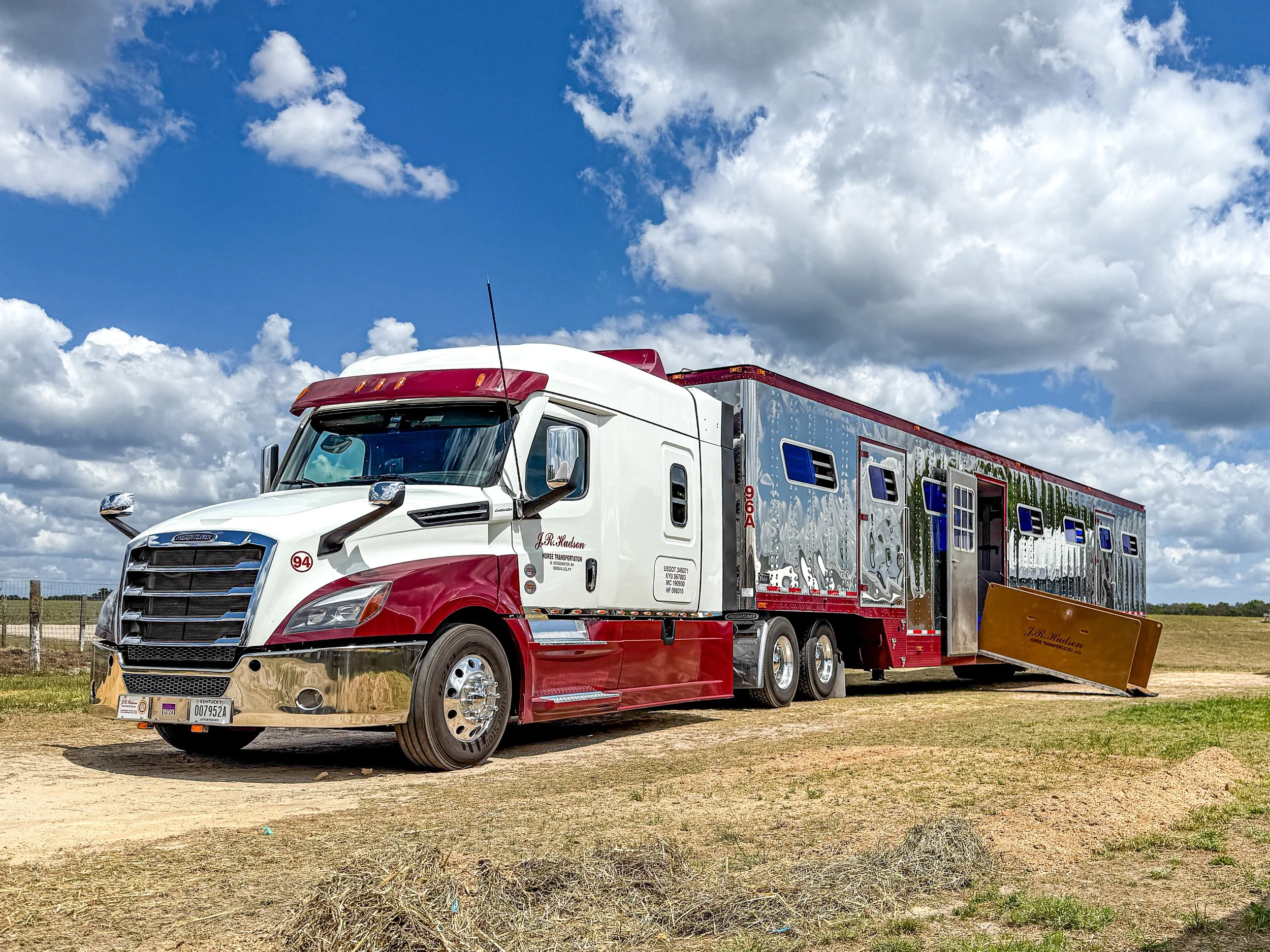 Freightliner Cascadia with 16 horse semi trailer loading standardbreds