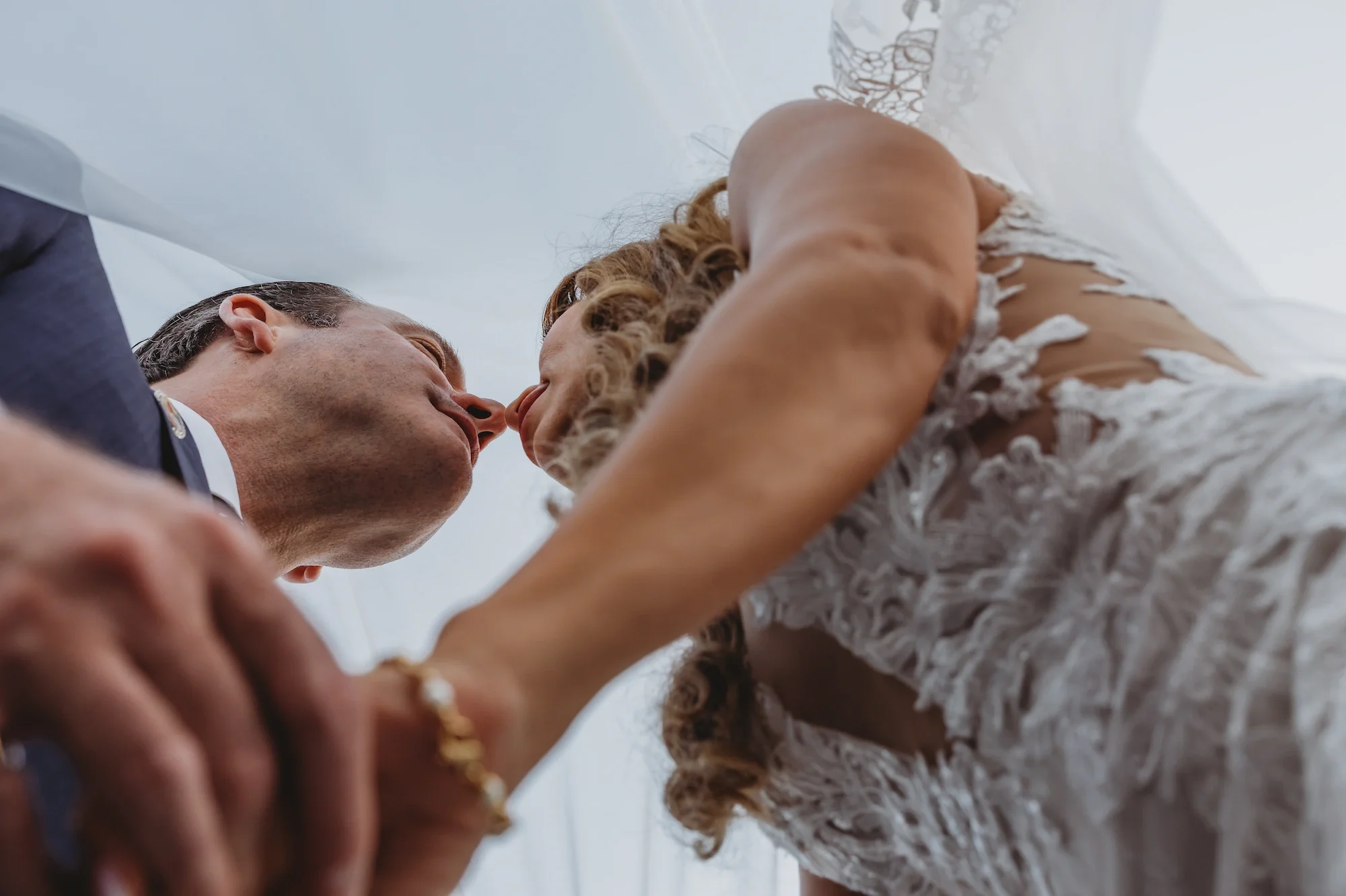 Pebble Beach partially planned service with bride and groom holding hands and looking into each other's eyes